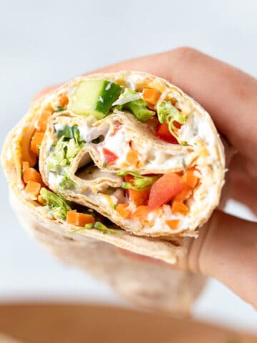 Veggie Wrap cut open showing vegetables and ranch.