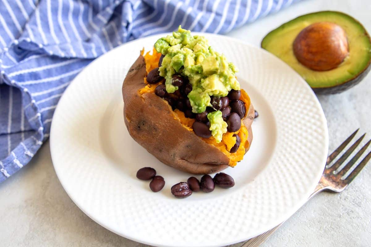 Baked sweet potato with black beans and avocado.