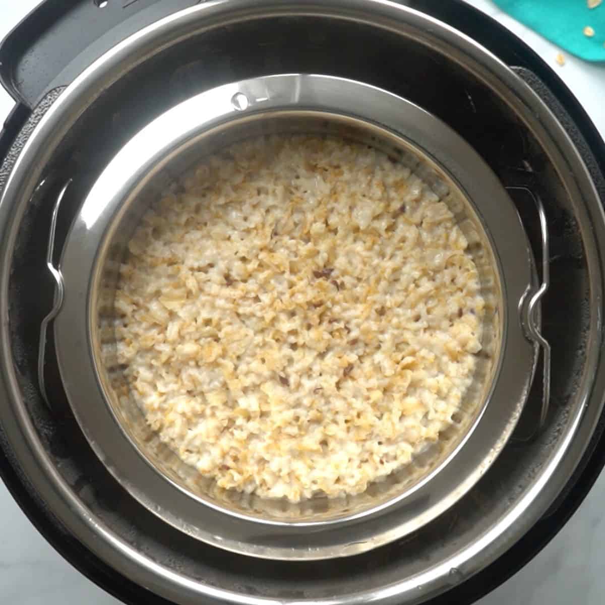 Cooked oatmeal inside stainless steel pot inside Instant Pot.
