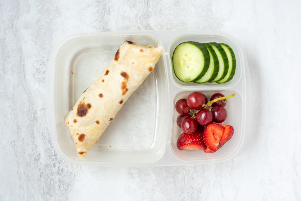 Bean Burrito with strawberries, grapes, and cucumbers.