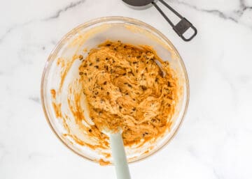 Mixing bowl with pumpkin chocolate chip cookie dough.