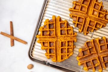 Sweet Potato Waffles on baking rack over sheet pan after being cooked.