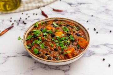 Bowl of sweet potato black bean chili topped with minced cilantro.