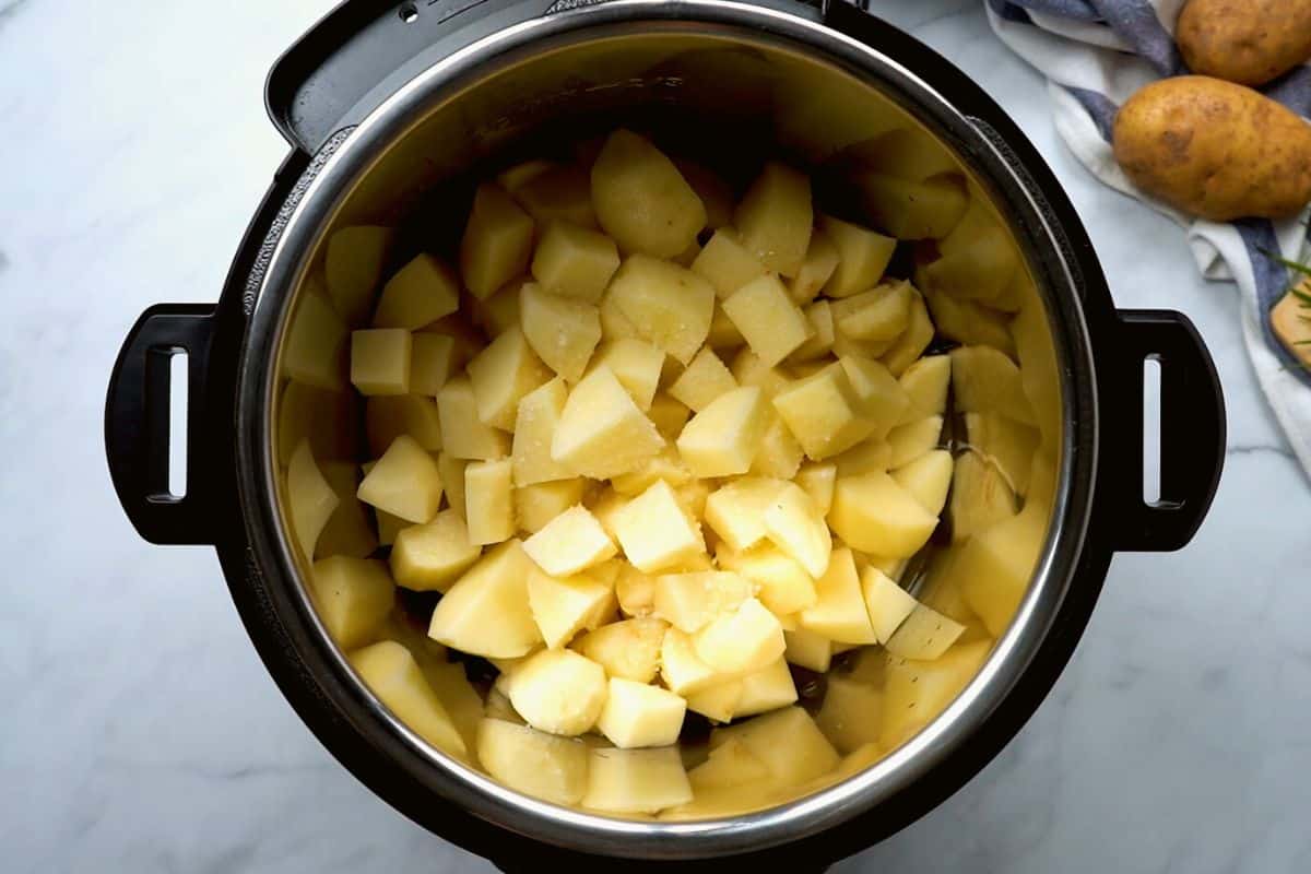 cubed potatoes inside inner pot of Instant Pot.