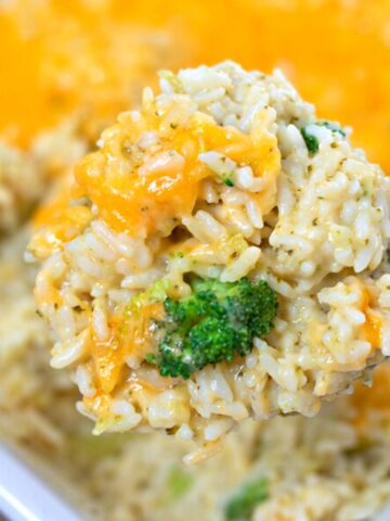 Scoop of homemade broccoli rice casserole with tons of cheese.