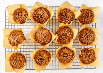 Baked Cranberry Orange Muffins with streusel on cooling rack.