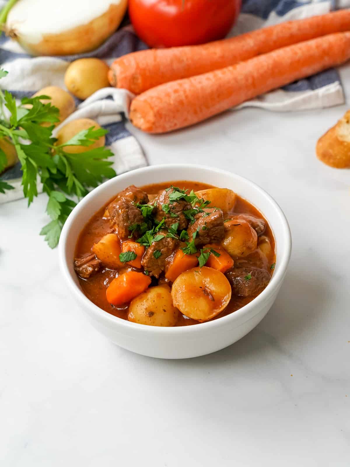 Bowl of instant pot beef stew topped with parsley.