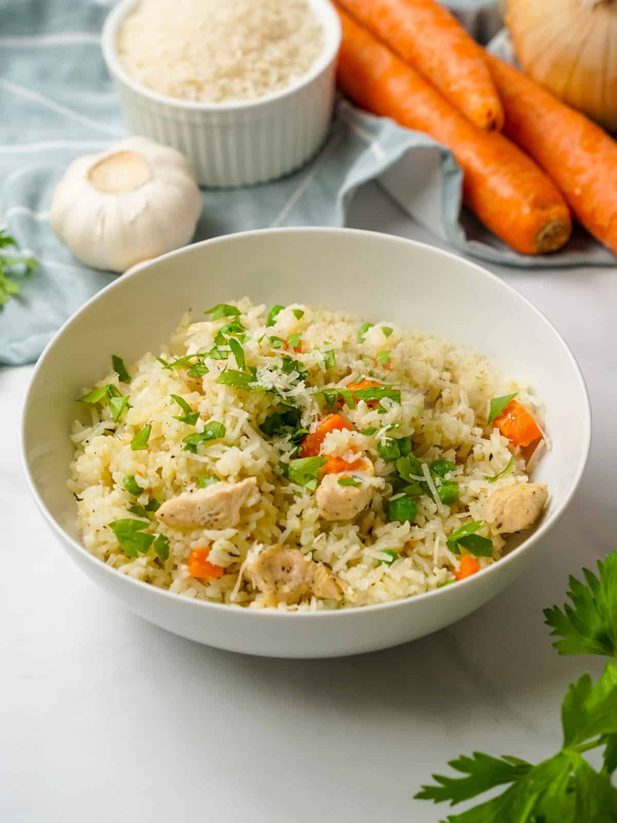 Instant Pot Chicken and Rice dished up in white bowl topped with parsley.