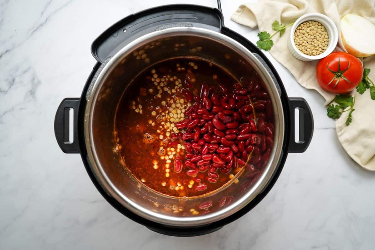 Ingredients for Vegan lentil chili inside instant pot before adding tomatoes. 