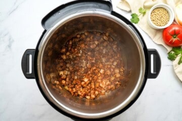 Onions and spices toasted in inner pot inside Instant Pot.