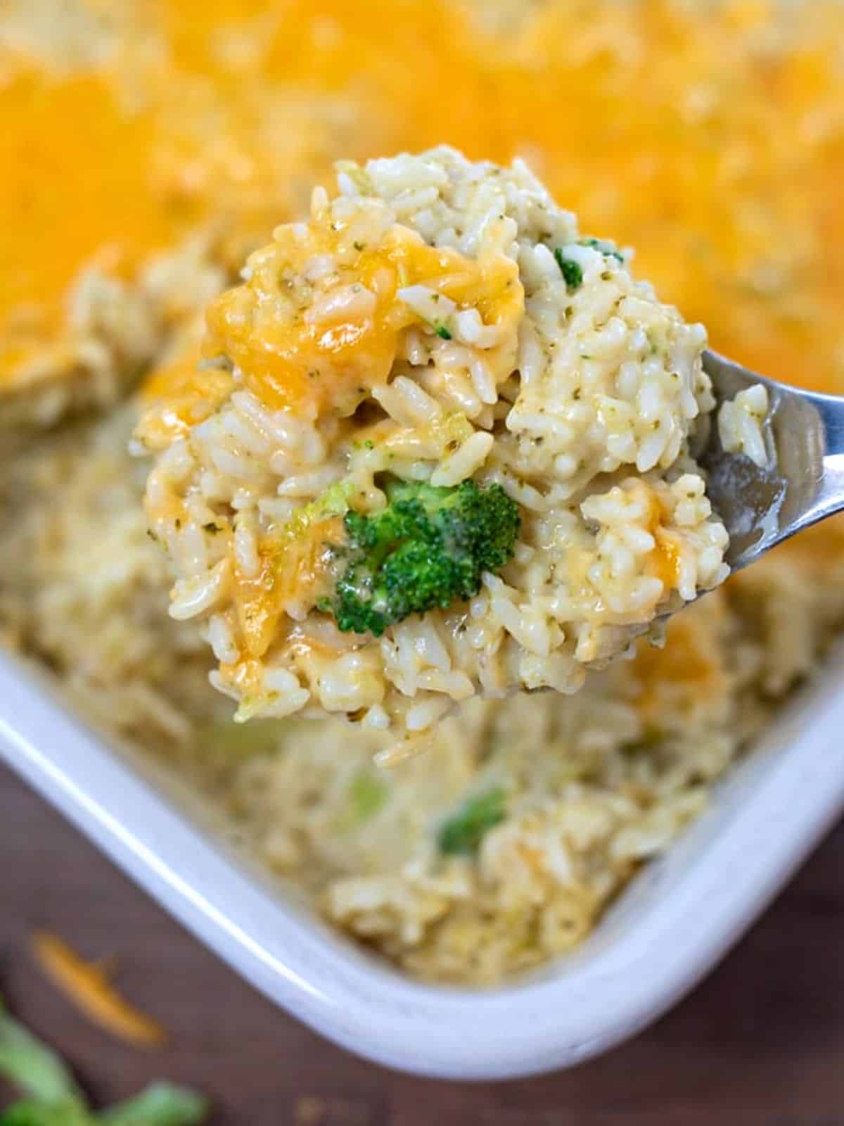 Scoop of homemade broccoli rice casserole with tons of cheese.