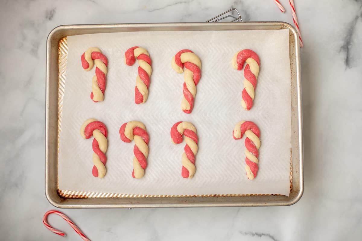 Baked Candy Cane Cookies dusted with sparkling sugar.