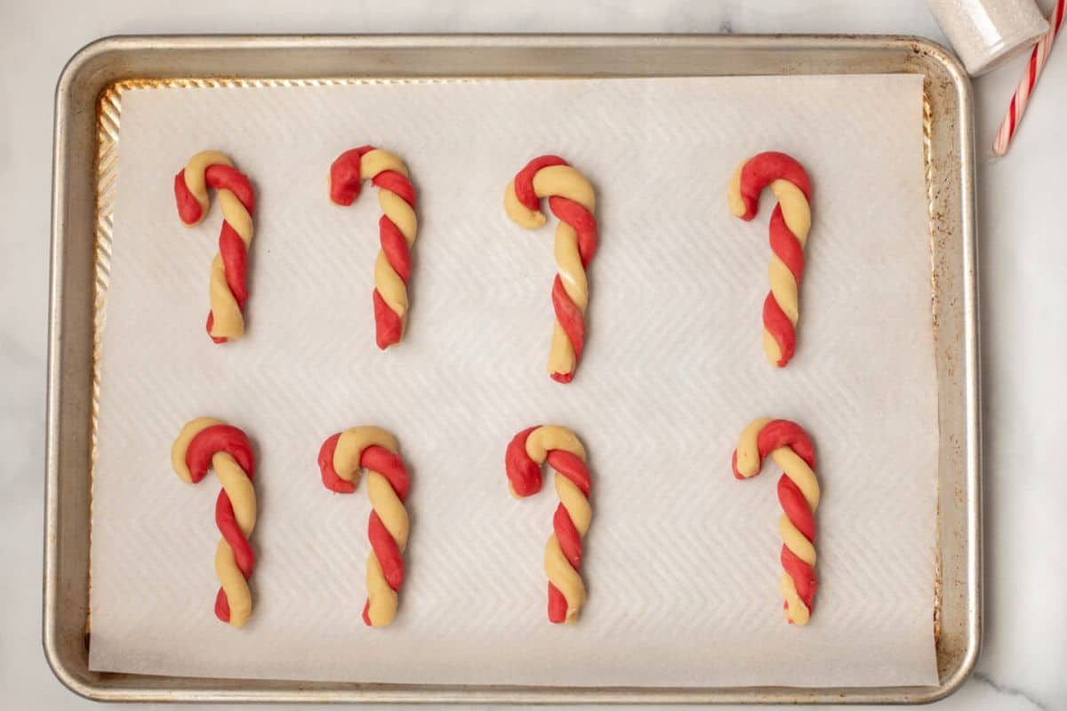 Shaped Candy Cane Cookies on parchment paper.