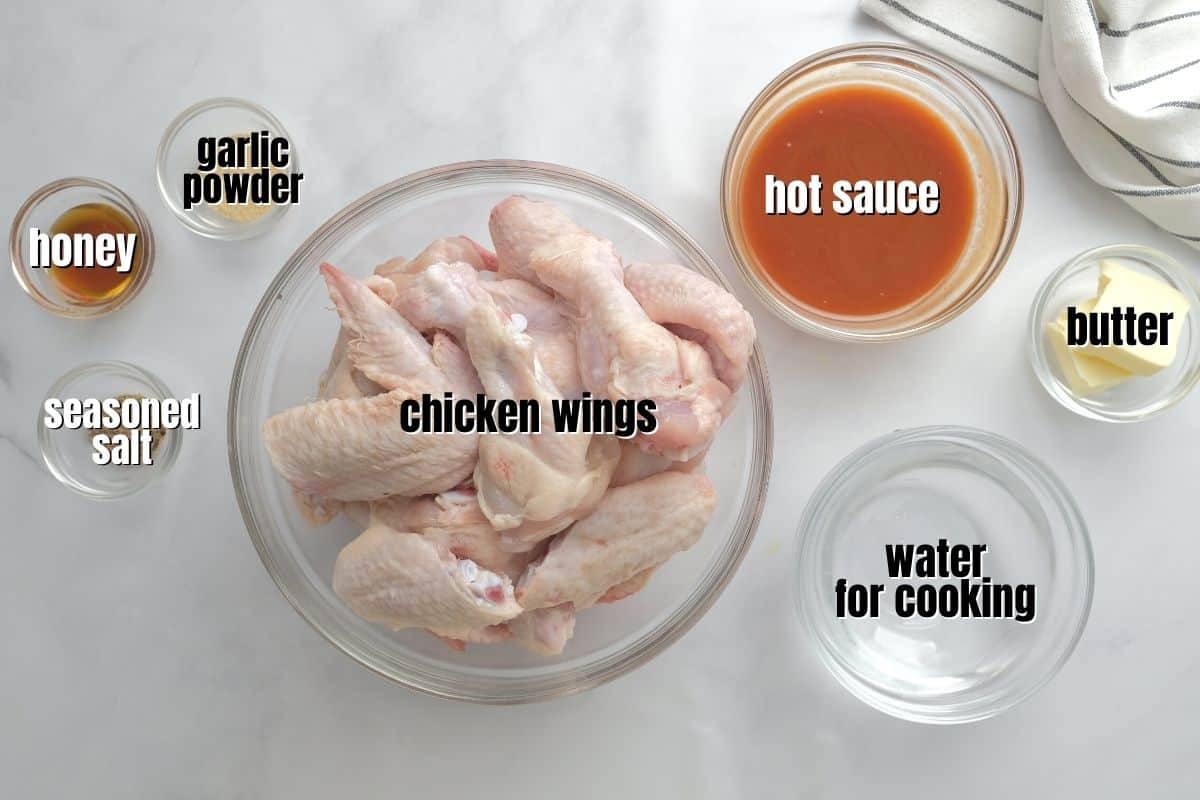 Ingredients for instant pot chicken wings labeled on counter.