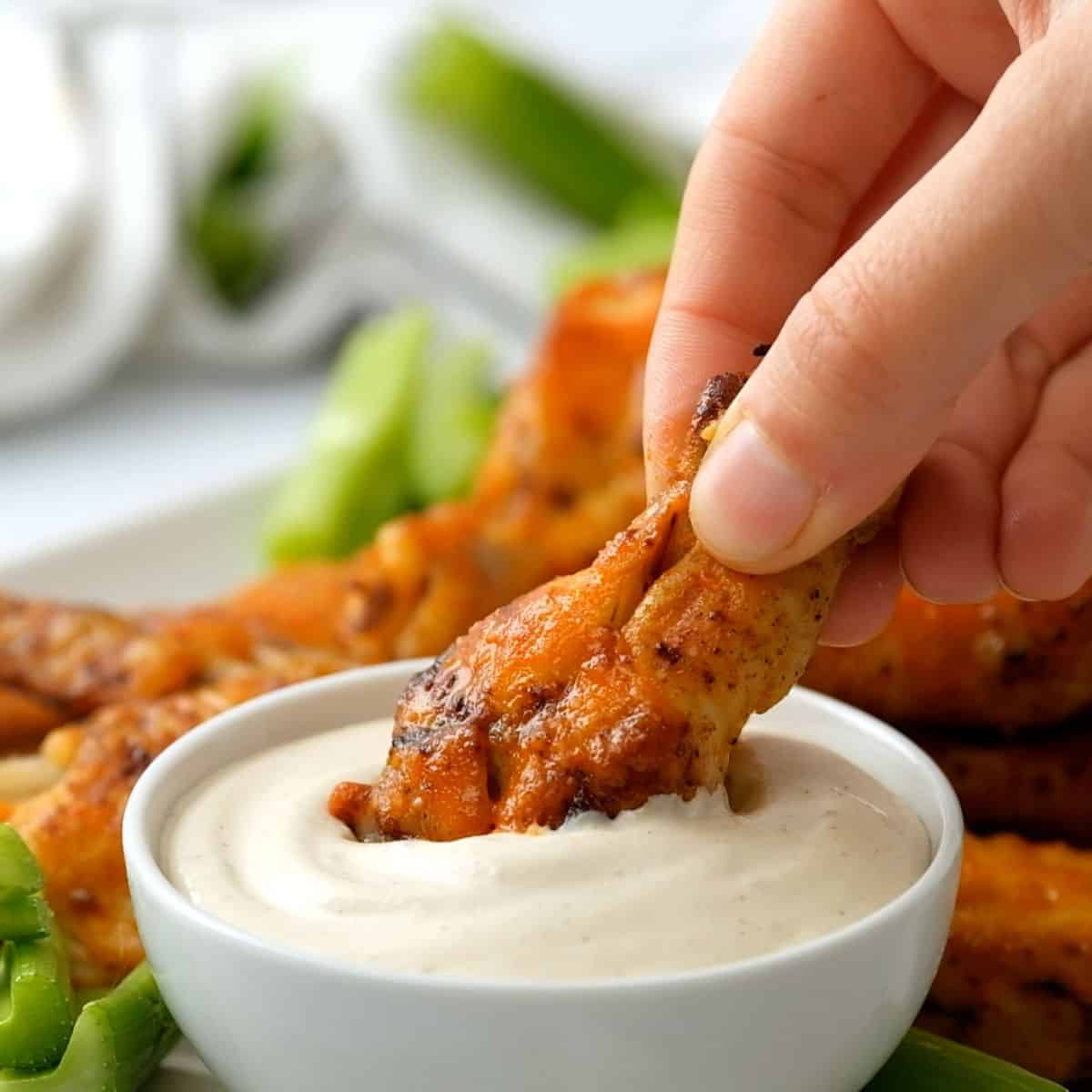 Instant Pot Chicken Wing being dipped into ranch dressing.