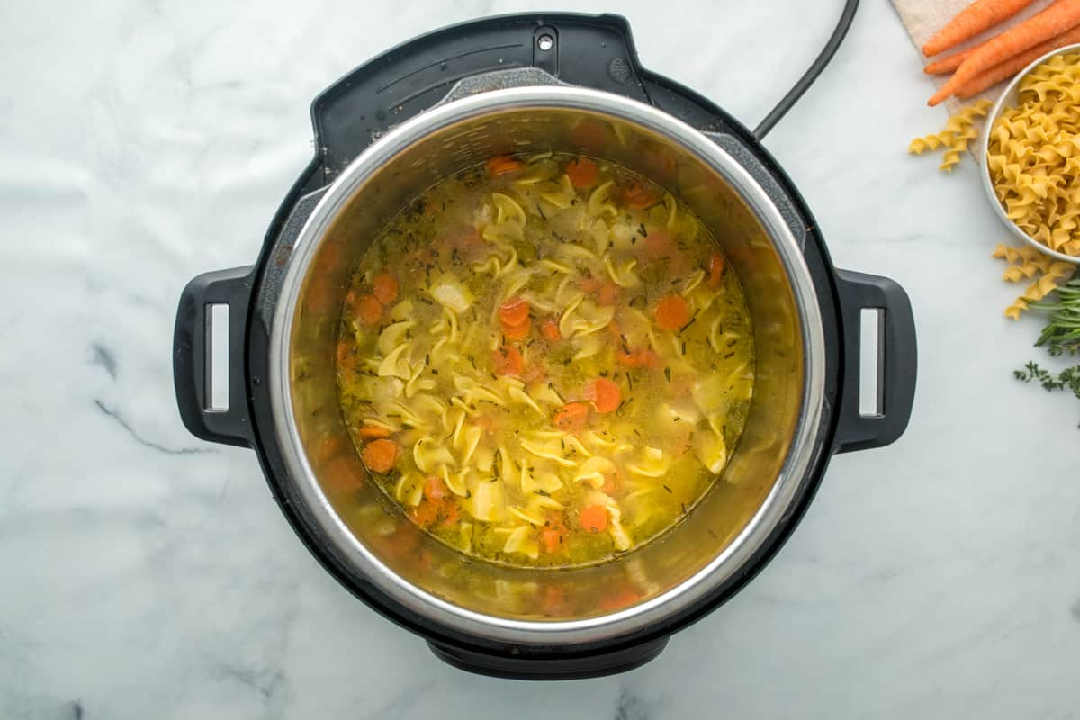 Chicken noodle soup cooked in inner pot of instant pot.