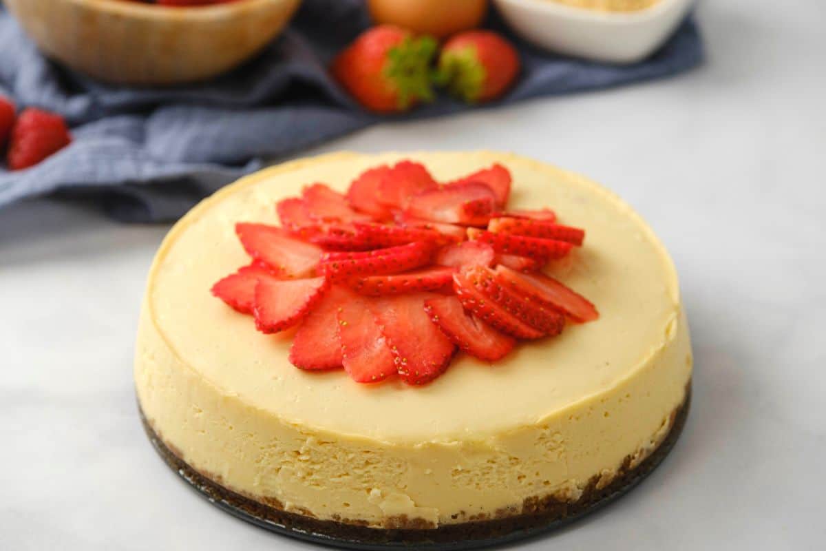 Cheesecake topped with sliced strawberries.