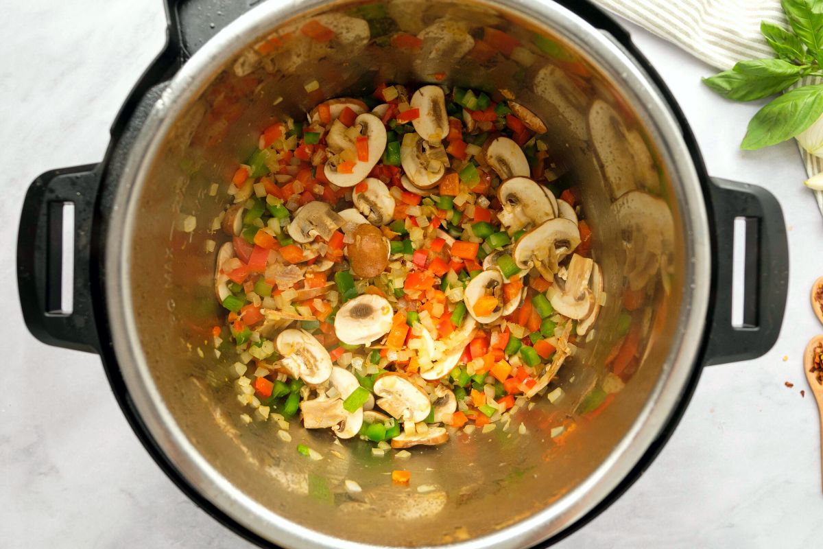 Onions, peppers, and mushrooms sauteed inside inner pot.