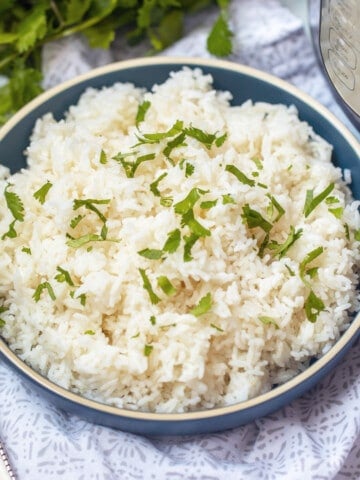 Bowl of instant pot jasmine rice topped with parsley.