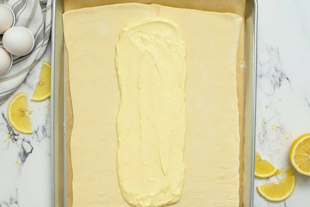 Cream Cheese Filling spread out on center of puff pastry.