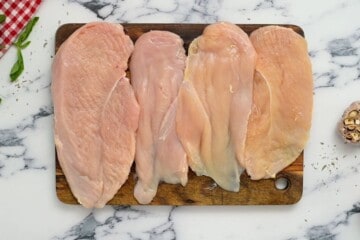4 chicken cutlets pounded thin on cutting board.