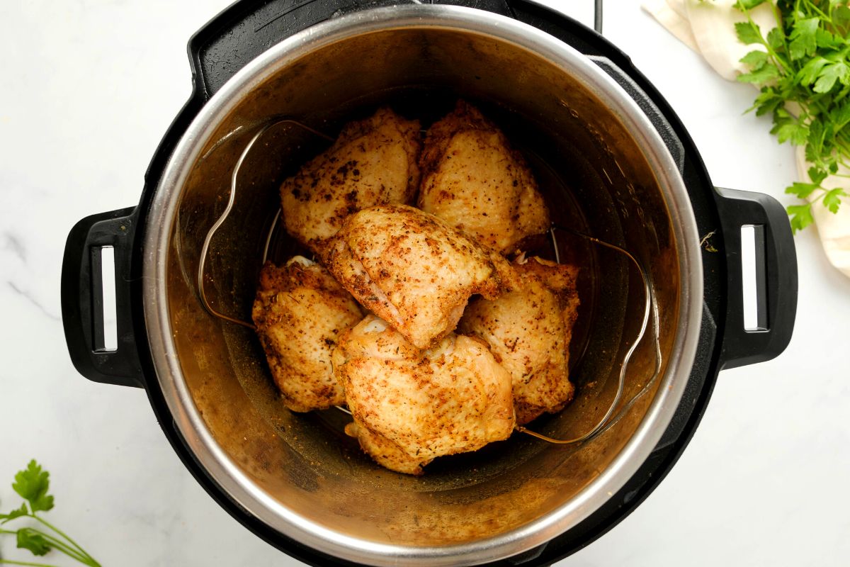 Seared chicken thighs inside instant pot.