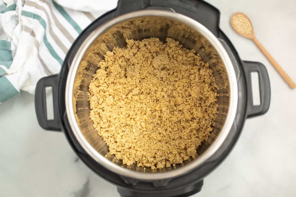 Perfectly cooked white quinoa inside inner pot of instant pot.