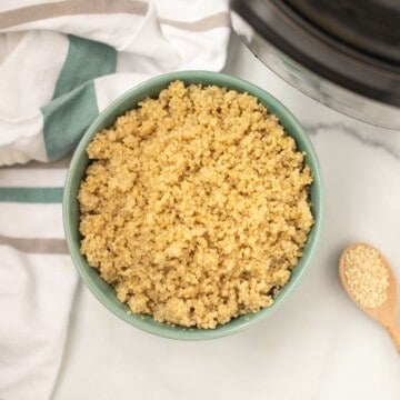 Bowl of instant pot quinoa next to the instant pot.