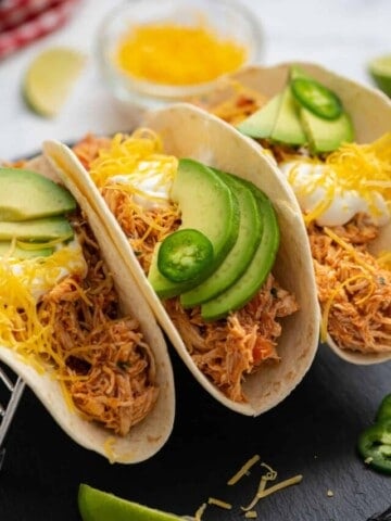 Shredded Mexican Chicken served on three flour tortillas, topped with shredded cheese, avocado, and sour cream.