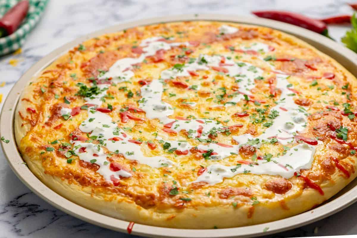 Baked Buffalo Chicken Pizza with swirl of ranch dressing.