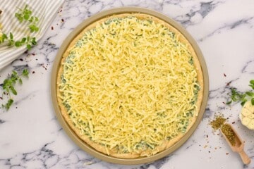Pizza Crust with spinach, ricotta, and mozzarella cheese.