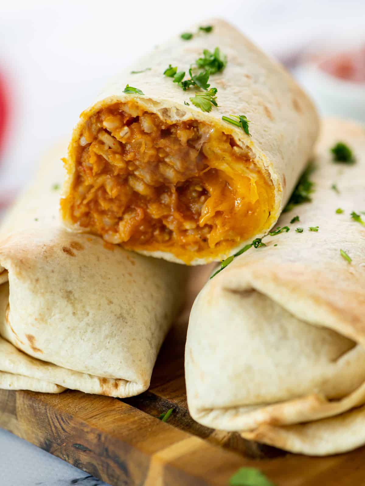 Bean Burrito Cut open to show rice, cheese and refried bean filling.
