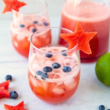 Watermelon Sangria in glass with watermelon stars garnished with blueberries.