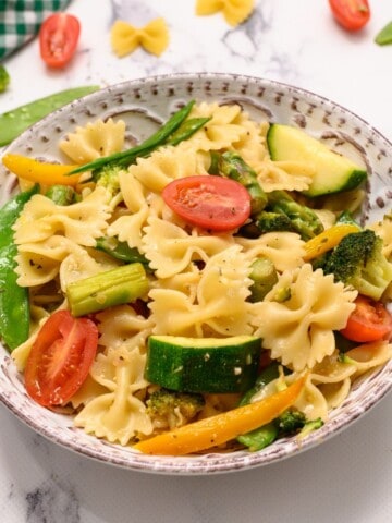 Bowl of pasta with fresh spring vegetables.