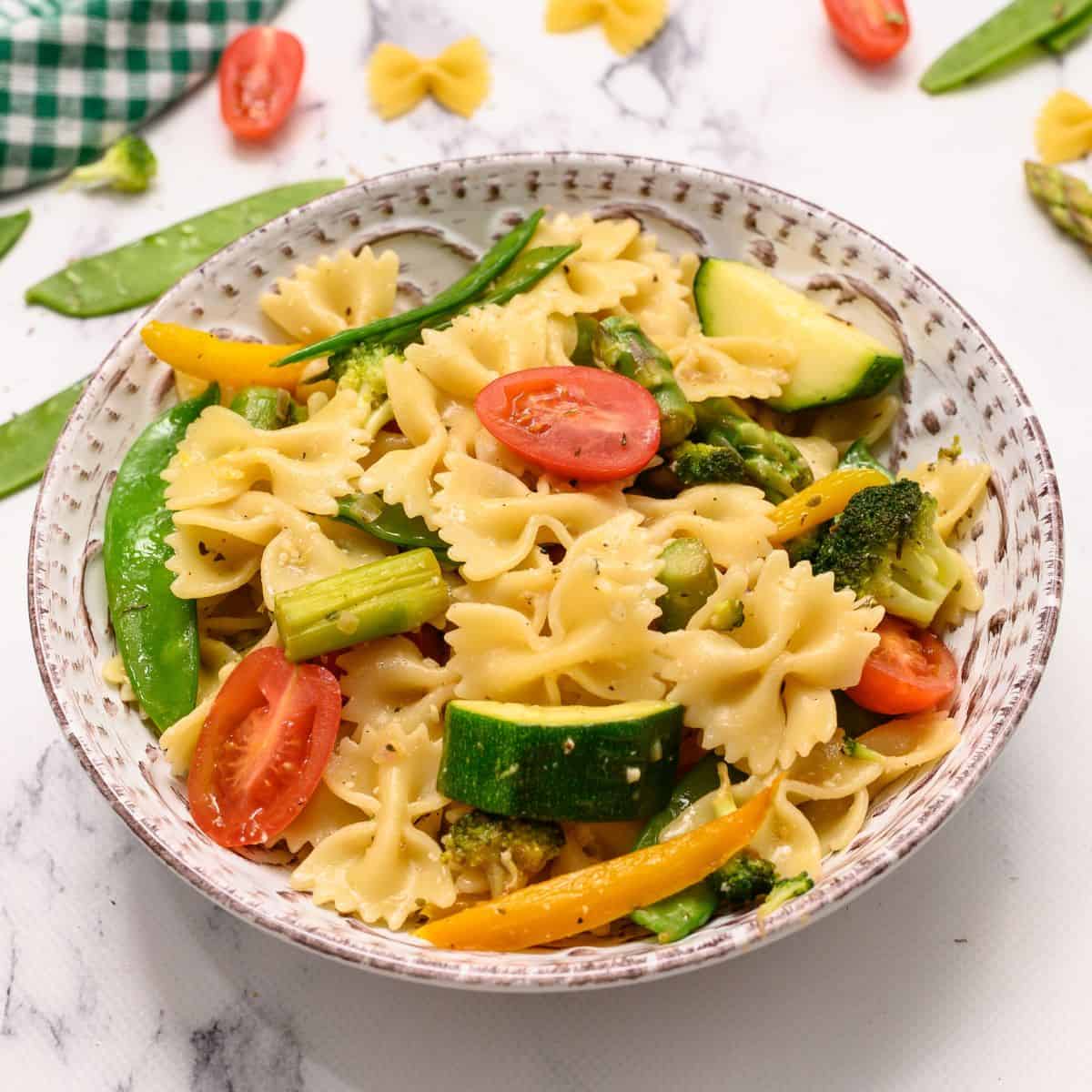 Bowl of pasta with fresh spring vegetables.