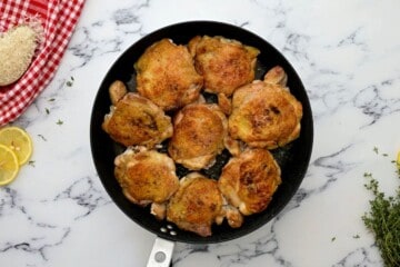 Seared chicken thighs in large saute pan.
