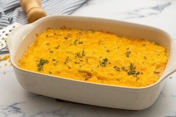 Casserole dish with baked cheesy chicken and rice.