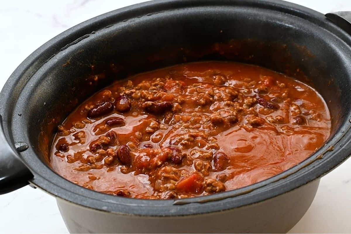 Crockpot filled with simmered beef and beef chili.