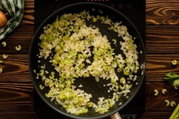 Onions and celery in saute pan after briefly sauteeing in butter.