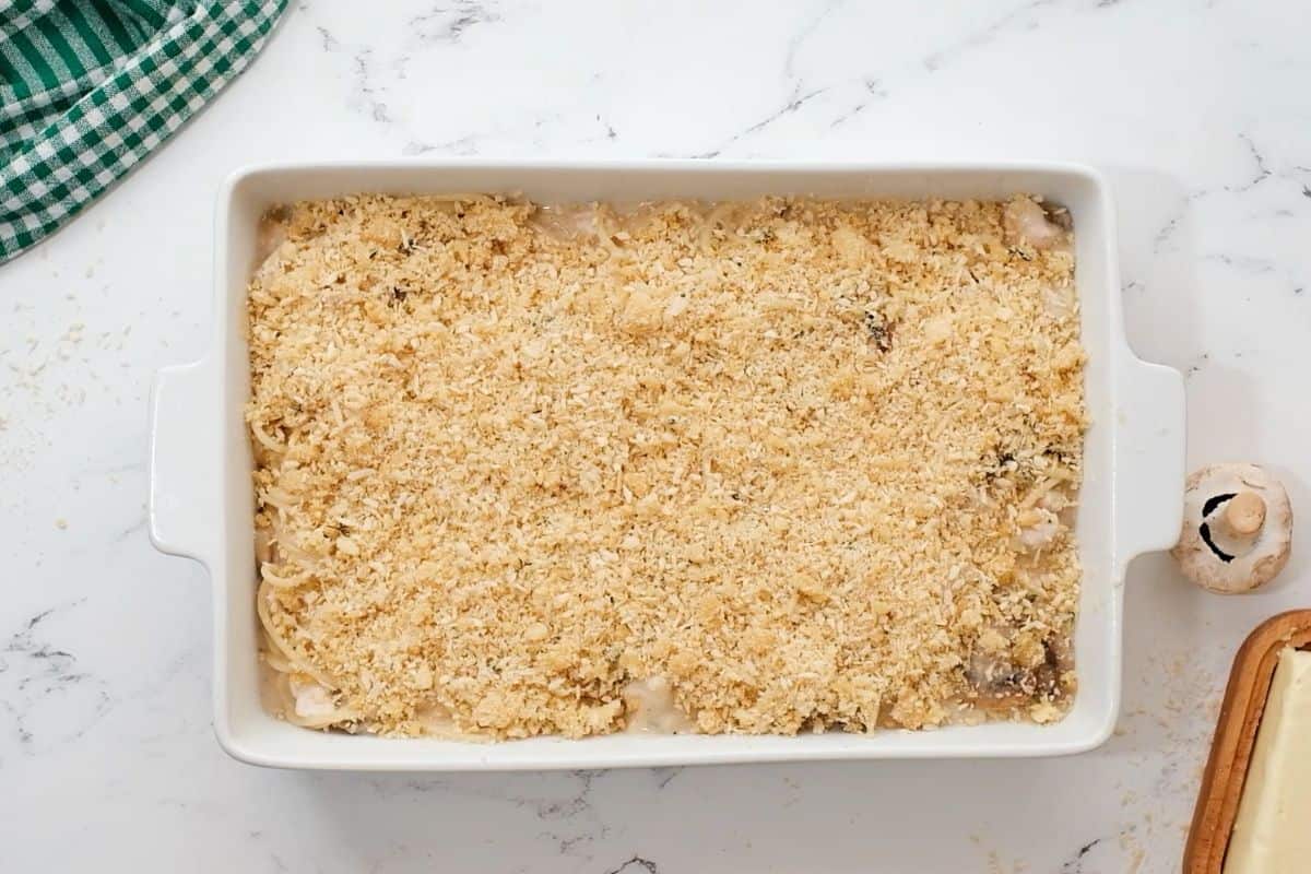 Turkey Casserole with bread crumb topping in white casserole dish.