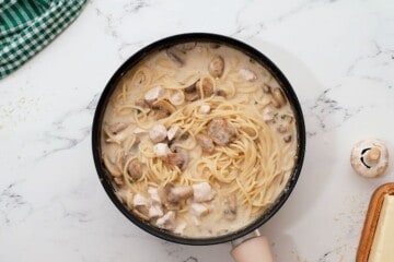 Cooked noodles and turkey tossed with mushroom sauce in large skillet.
