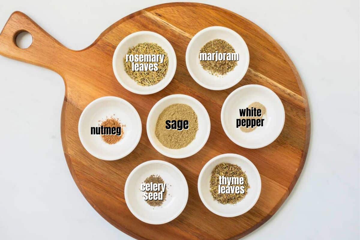 spices for poultry seasoning in small white dishes labeled with text.