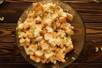 Bowl of bread stuffing after mixing together with onions and celery.