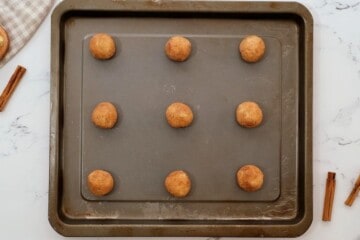 Snickerdoodle Cookie Dough on baking sheet placed 2 inches apart.