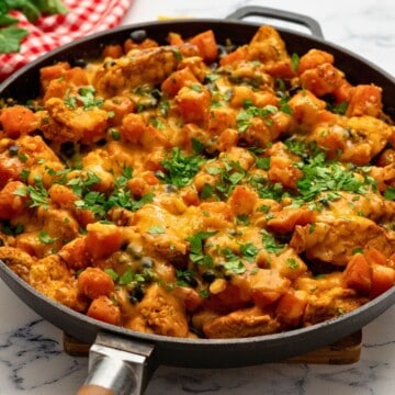 Cheesy Chicken and Sweet Potatoes with Beans and Corn in skillet topped withe cilantro.