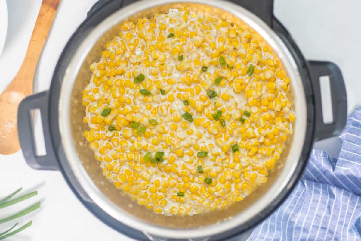 Easy Thanksgiving Recipes for Instant Pot Instant Pot with creamed corn topped with green onions.