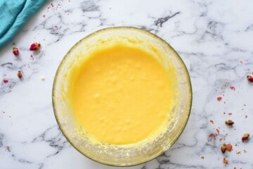 Creamed butter, sugar, eggs, and vanilla extract in large mixing bowls.
