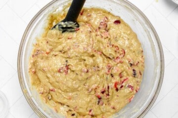 Mixing Bowl filled with cranberry orange muffin batter.