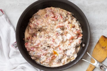 Cream cheese, rotel tomatoes and sausage in saute pan.