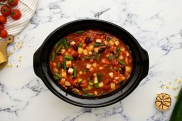 Slow Cooker with ingredients for minestrone before cooking.